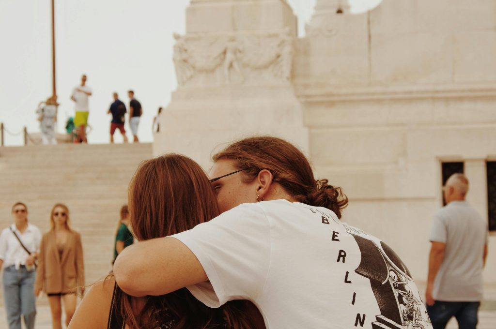 pexels-photo-10315145-10315145 Couple sharing a romantic moment at a historic site in Rome.